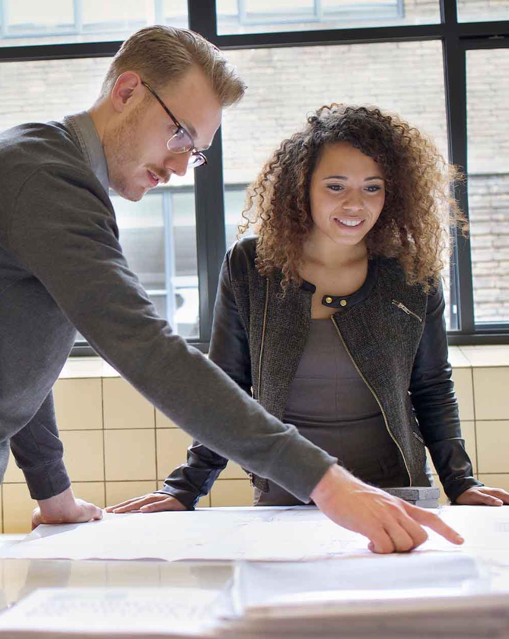 Woman and man going over documents in office